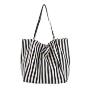 Black and white striped canvas shoulder bag for women, high capacity casual shopping tote.