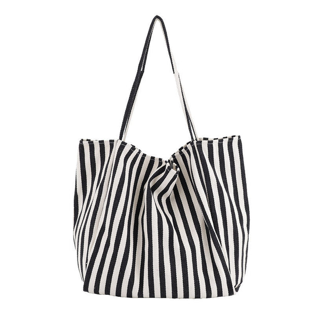 Black and white striped canvas shoulder bag for women, high capacity casual shopping tote.