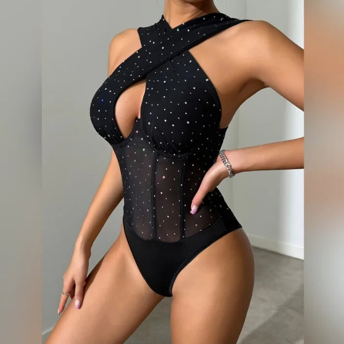 Women's black sequin studded slim fit sleeveless backless jumpsuit with sheer mesh and crisscross neckline for summer nightclub party