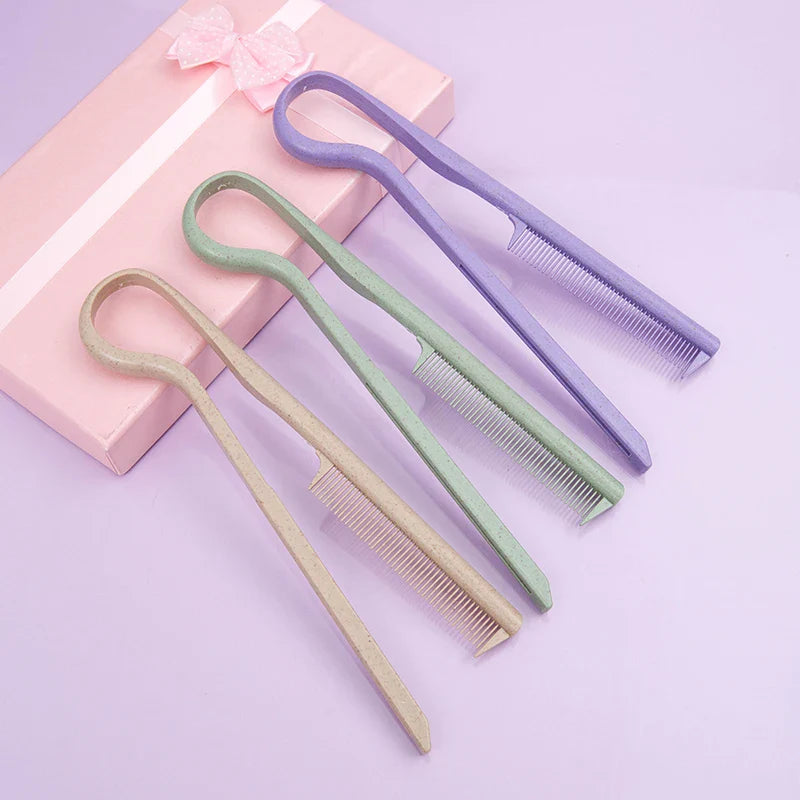 Set of three wheat straw V-shaped flat combs in beige, green, and purple colors on a purple surface next to a pink gift box with a ribbon.