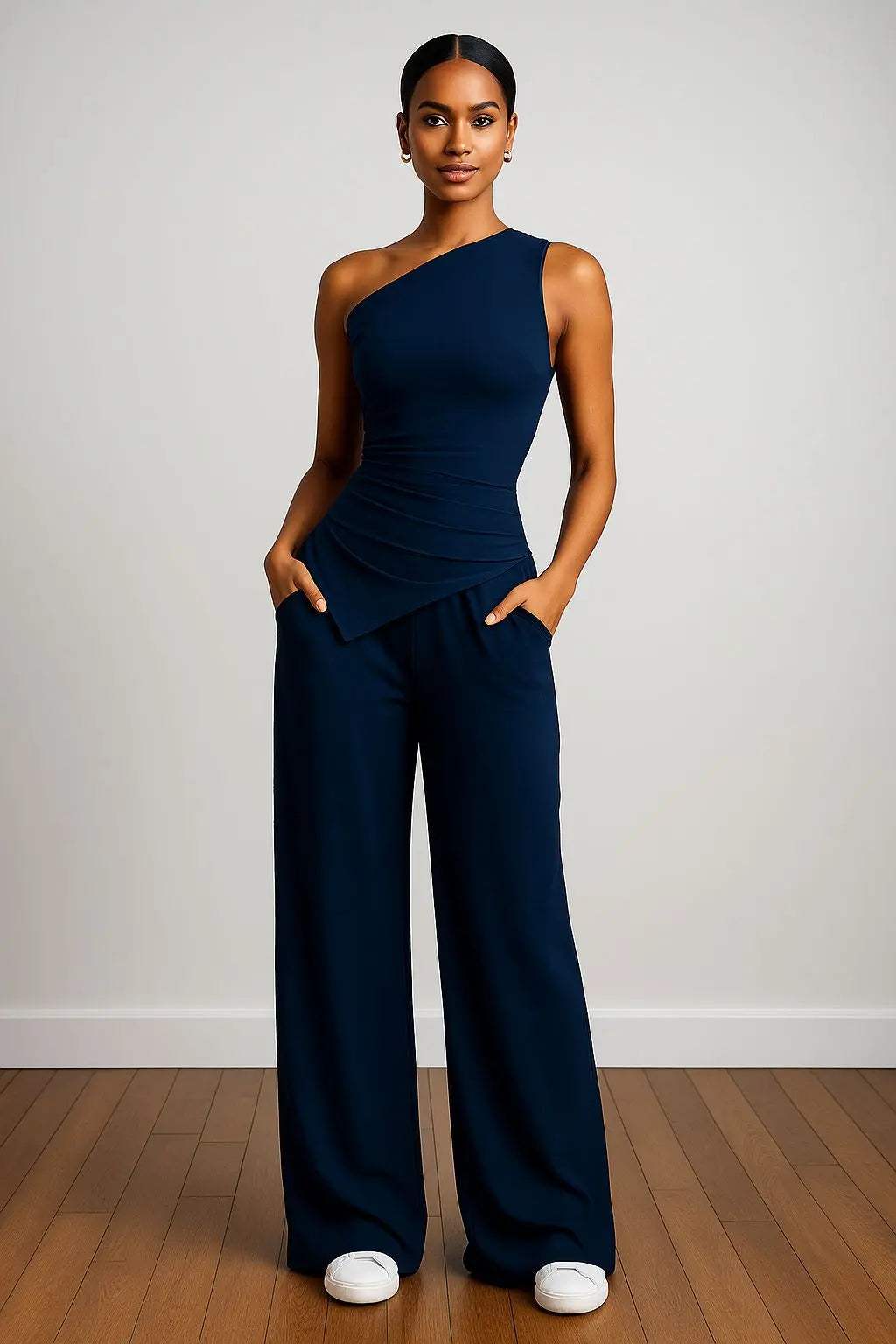 Woman wearing navy blue asymmetrical Summer Basics Set with wide-leg pants and white sneakers