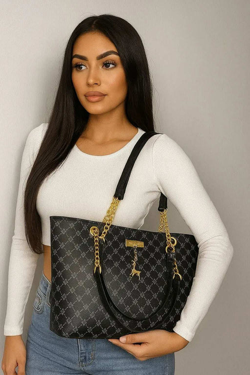 Woman wearing white top holding luxury leather shoulder bag with gold chain straps and black patterned design