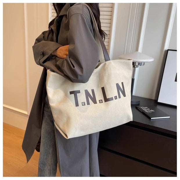 Canvas letter printed tote bag in off-white color with large capacity, perfect for women and college students.